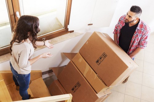 Westkensington moving team loading furniture into a van on a city street